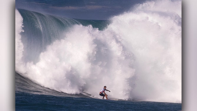Hawaiian surfer Koa Rothman catches a wave during the 2024 Rip Curl Eddie Aikau Big Wave invitational on the north shore of Oahu, Hawaii, on December 22, 2024.