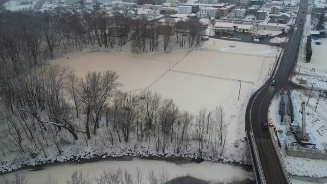 This photo shows the ground in Rumford, Maine, coated with brown and tan snow after a malfunction at a paper mill on Tuesday, Dec. 10, 2024.