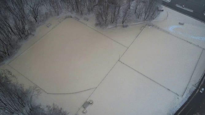 This photo shows the ground in Rumford, Maine, coated with brown and tan snow after a malfunction at a paper mill on Tuesday, Dec. 10, 2024.