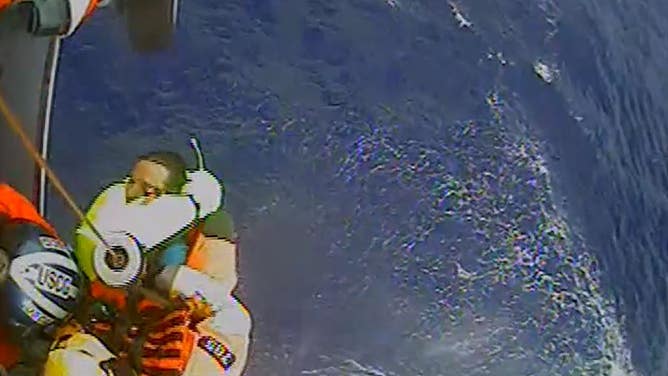 Mariner pulled up into Coast Guard helicopter after abandoning their boat during bad weather. 