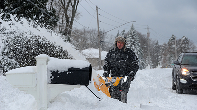 HAMBURG, NEW YORK - DECEMBER 01: Tom Szczerbacki begins the task of removing the near two feet of lake effect snow from his home on December 1, 2024 in Hamburg, New York. The North Eastern storm that closed a ninety mile stretch of The New York State Thruway and snarled holiday traffic across the country dumped more than four feet of snow around Buffalo and its southern suburbs and is expected to continue throughout the weekend. (Photo by John Normile/Getty Images)