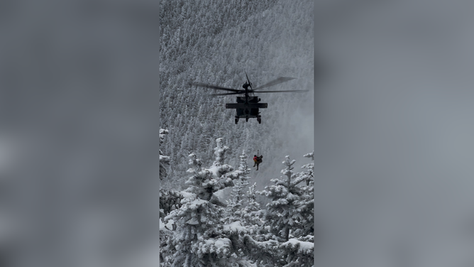 View of Bittman and medic being hoisted by the helicopter.