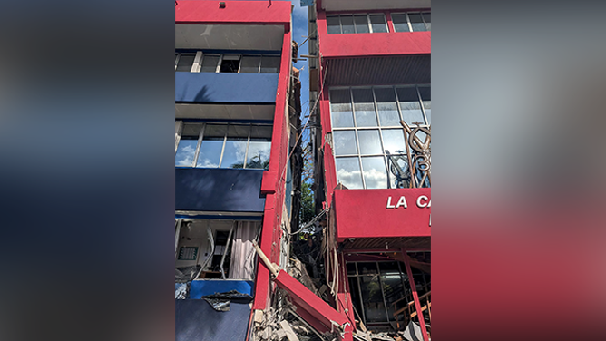 This photo shows a general view of a severely damaged building housing the embassies of the United States, United Kingdom, and New Zealand after a powerful earthquake struck Port Vila, the capital city of Vanuatu, on December 17, 2024. A powerful earthquake hit the Pacific island of Vanuatu on December 17, smashing buildings in the capital Port Vila including one housing the US and other embassies, with a witness telling AFP of bodies seen in the city. (Photo by AFP) (Photo by STR/AFP via Getty Images)