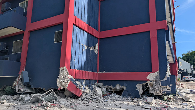 This photo shows a general view of a severely damaged building housing the embassies of the United States, United Kingdom, and New Zealand after a powerful earthquake struck Port Vila, the capital city of Vanuatu, on December 17, 2024. A powerful earthquake hit the Pacific island of Vanuatu on December 17, smashing buildings in the capital Port Vila including one housing the US and other embassies, with a witness telling AFP of bodies seen in the city. (Photo by AFP) (Photo by STR/AFP via Getty Images)