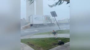 Video: Winds blow surfboard from surfer's hands during strong Australia storm