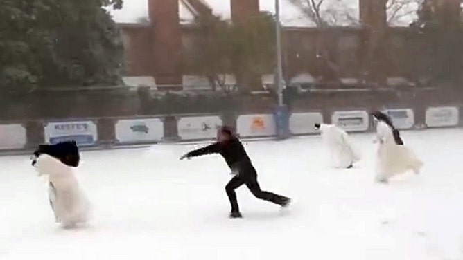 A group of nuns engaged in a snowball fight with a priest at St. Catherine of Siena Catholic Church & School in Metairie, Louisiana, during a snowstorm on Tuesday.