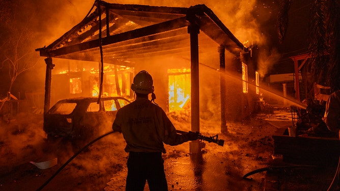 Firefighters battle the Eaton Fire on January 8, 2025 in Altadena, California.