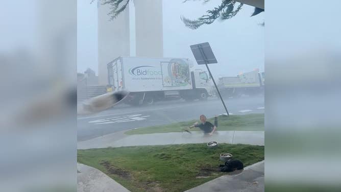 Surfboard is blown away from a surfer who fell seeking shelter during a storm in Australia. 