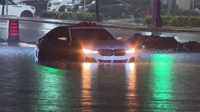 FILE - This image shows a vehicle stuck in flooding near Dallas Love Field.