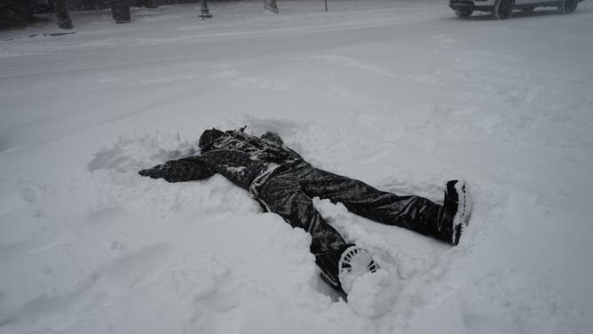 A man makes a snow angel in New Orleans.