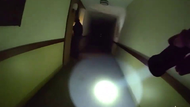 This image taken from bodycam video shows the dark hallways inside a senior living apartment complex in Altadena, California, as the Eaton Fire approached.