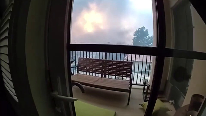 This image taken from bodycam video shows smoke from the Eaton Fire approaching a senior living apartment complex in Altadena, California.