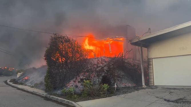 The Palisades Fire burns a building in the Pacific Palisades neighborhood in Los Angeles. 