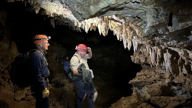 Tom Howells (Utah Field House of Natural History) and David Herron (US Forest Service) admiring the cave formations on the trip back to the fox skeleton.