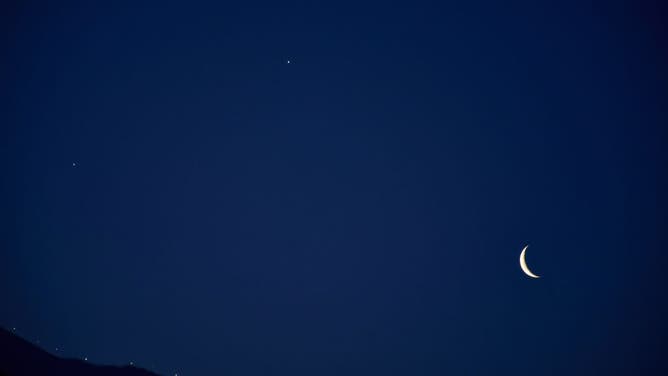 2022 FILE IMAGE: A crescent moon along with Venus is seen during a rare alignment of four planets, Venus, Jupiter, Mars, and Saturn in Srinagar.