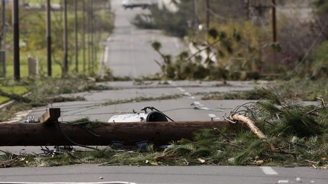 PASADENA, CA - DECEMBER 1: Fallen power poles block a street as strong Santa Ana Winds cause the worst local wind damage in decades on December 1, 2011 in Pasadena, California. As many as 230,000 were without power and the city of Pasadena closed schools and declared a state of emergency. (Photo by David McNew/Getty Images)
