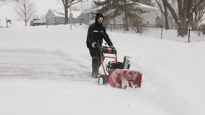 SHAWNEE, KANSAS - JANUARY 5: Darin Campbell uses a snow blower to remove snow from his driveway on January 5, 2025 in Shawnee, Kansas. A large swath of the U.S., across the Midwest to the East Coast is experiencing a major Winter storm, with more than two feet of snow in some areas. A state of emergency has been declared in Kentucky and Virginia. (Photo by Chase Castor/Getty Images)