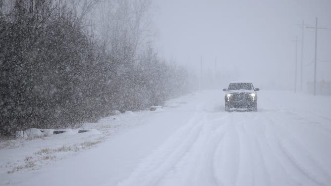 LOUISVILLE, KENTUCKY - JANUARY 5: A motorist drives through the snow near Louisville Muhammad Ali International Airport on January 5, 2025 in Louisville, Kentucky. Local forecasts called for heavy snowfall followed by significant accumulation of freezing rain and ice. (Photo by Luke Sharrett/Getty Images)