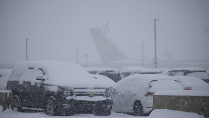 LOUISVILLE, KENTUCKY - JANUARY 5: Snow-covered vehicles sit parked near Louisville Muhammad Ali International Airport on January 5, 2025 in Louisville, Kentucky. Local forecasts called for heavy snowfall followed by significant accumulation of freezing rain and ice. (Photo by Luke Sharrett/Getty Images)