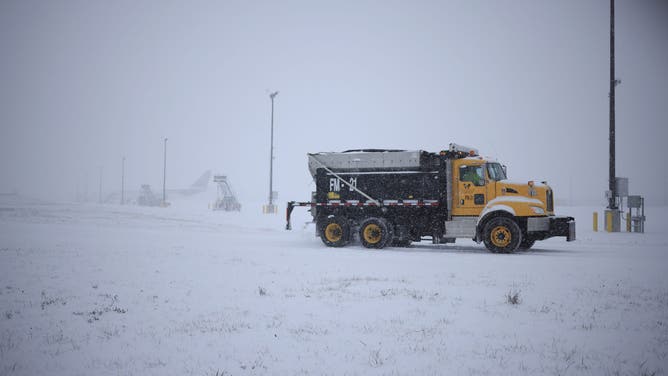 LOUISVILLE, KENTUCKY - JANUARY 5: A dump truck spreads salt along the tarmac at Louisville Muhammad Ali International Airport on January 5, 2025 in Louisville, Kentucky. Local forecasts called for heavy snowfall followed by significant accumulation of freezing rain and ice. (Photo by Luke Sharrett/Getty Images)