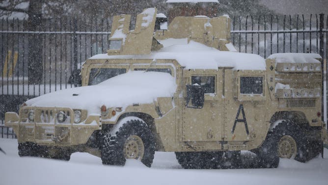 LOUISVILLE, KENTUCKY - JANUARY 5: A snow-covered Humvee military vehicle sits parked at the Kentucky Air National Guard base at Louisville Muhammad Ali International Airport on January 5, 2025 in Louisville, Kentucky. Local forecasts called for heavy snowfall followed by significant accumulation of freezing rain and ice. (Photo by Luke Sharrett/Getty Images)