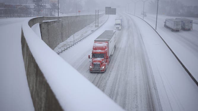 LOUISVILLE, KENTUCKY - JANUARY 5: Semi trucks drive through the snow along I-264 on January 5, 2025 in Louisville, Kentucky. Local forecasts called for heavy snowfall followed by significant accumulation of freezing rain and ice. (Photo by Luke Sharrett/Getty Images)