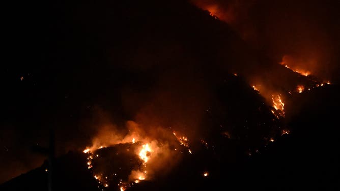 Pasadena, CA - January 08: The Eaton Fire burns above Sierra Madre and Monrovia on Wednesday, January 8, 2025.