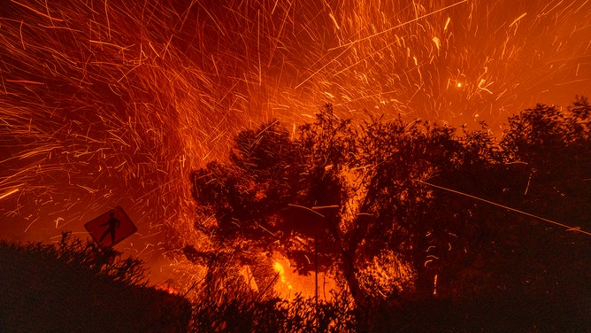 Strong winds blow embers from homes burning in the Eaton Fire on January 7, 2025 in Pasadena, California.