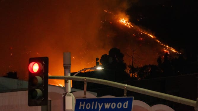 HOLLYWOOD, CA - JANUARY 08: Flames are seen on the hillsides above Hollywood Blvd. during the Sunset Fire on January 08, 2025 in Hollywood, California.