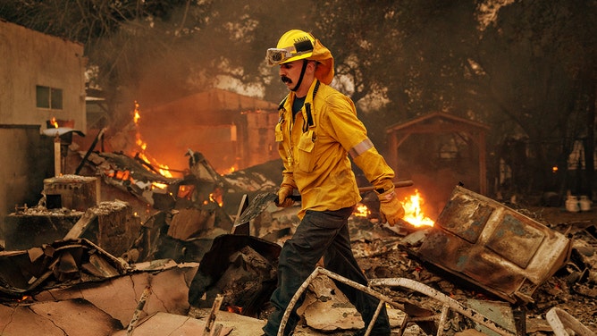 A firefighter works the Eaton fire on Wednesday, Jan. 8, 2025 in Altadena, CA.