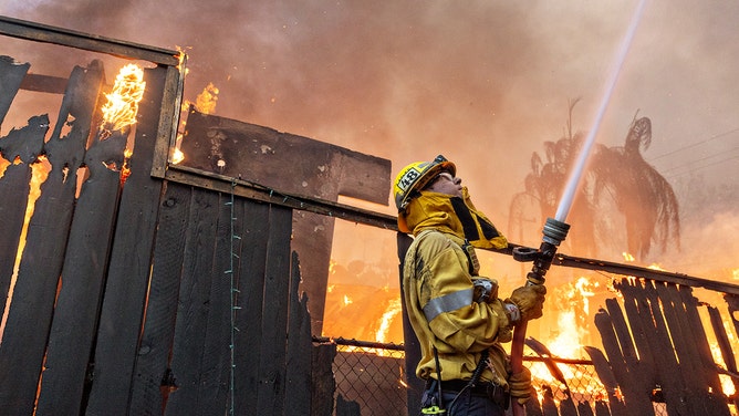 A firefighter works a fire during Eaton fire on Wednesday, Jan. 8, 2025 in Altadena, CA.