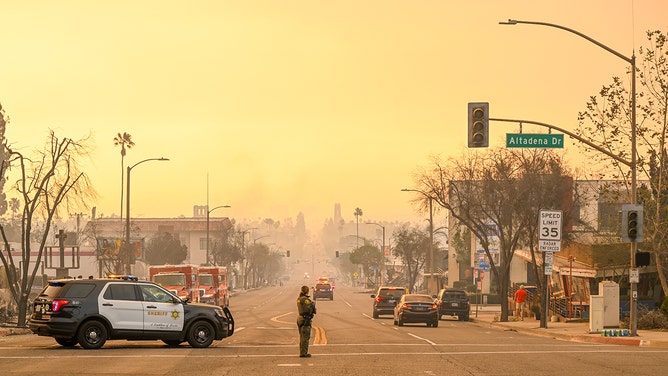 Police take security measures at the street during Eaton wildfire in Altadena of Los Angeles County, California, United States on January 9, 2025.