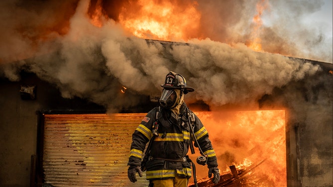 Firefighters work to put out a fire that broke out at the Altadena Golf Course Jan.09, 2025.