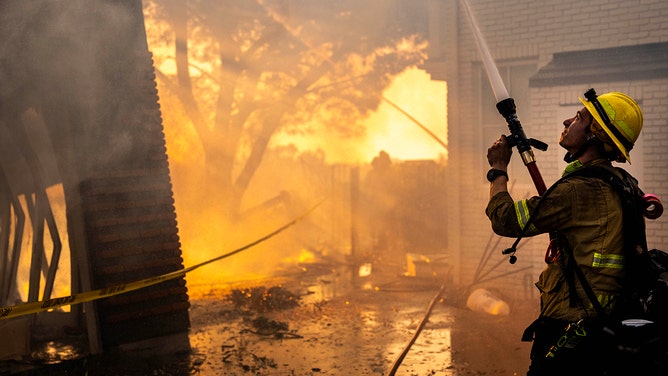 Orange County and Los Angles County firefighters work to save homes within the Palisades Fire zone in Pacific Palisades, California on Thursday January 9, 2025.