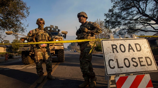 Members of the National Guard block entrances along New York Drive in the aftermath of the Eaton Fire in Altadena, California, US, on Friday, Jan. 10, 2025.