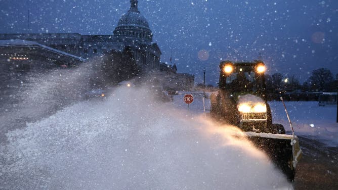 WASHINGTON, DC - JANUARY 06: Crews work before dawn to clear snow East Front Plaza of the U.S. Capitol as a winter storm slams into the nation's capital on January 06, 2025 in Washington, DC.