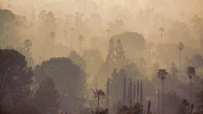 Smoke over destroyed homes in the aftermath of the Eaton Fire in Altadena, California, US, on Saturday, Jan. 11, 2025.