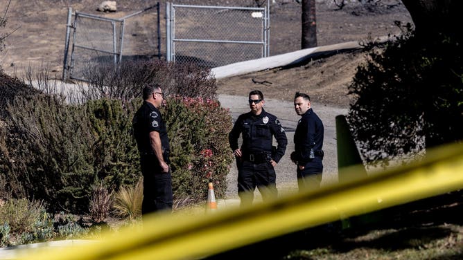 Pacific Palisades, CA - January 13: LAPD officers keep the public and media out of the Skull Rock Trailhead in an area that is under investigation as a potential starting point for the Palisades fire on Monday, Jan. 13, 2025 in Pacific Palisades, CA. (Brian van der Brug / Los Angeles Times via Getty Images)