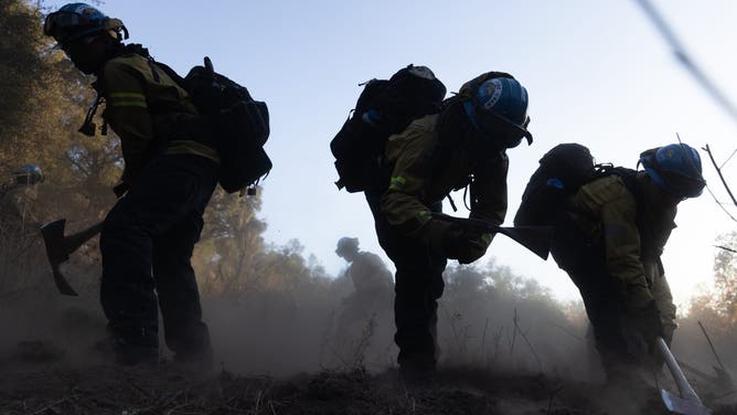 Firefighters from the California Conservation Corps work to contain the Eaton Fire in Altadena, California, US, on Monday, Jan. 13, 2025. Southern California faces another round of dangerous fire weather set to begin Monday night, even as crews struggle to contain wind-driven blazes that have paralyzed Los Angeles for nearly a week and killed at least 24 people. Photographer: Benjamin Fanjoy/Bloomberg via Getty Images