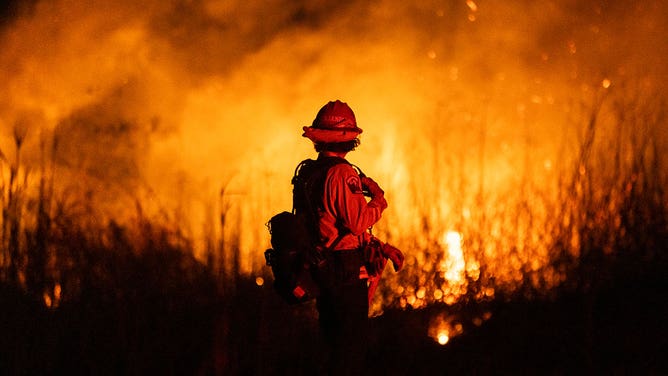 A firefighter monitors the spread of the Auto Fire in Oxnard, North West of Los Angeles, California, on January 13, 2025.