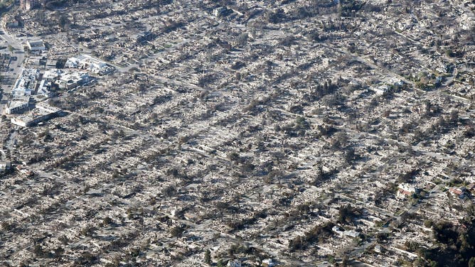 PACIFIC PALISADES, CALIFORNIA - JANUARY 13: An aerial view of homes destroyed in the Palisades Fire as wildfires cause damage and loss through the LA region on January 13, 2025 in Pacific Palisades, California. Multiple wildfires fueled by intense Santa Ana Winds continue to burn across Los Angeles County, with some containment achieved. According to reports, 24 people have died with over 180,000 people under evacuation order or warning. Over 12,000 structures have been destroyed or damaged, while more than 35,000 acres have burned. (Photo by Mario Tama/Getty Images)
