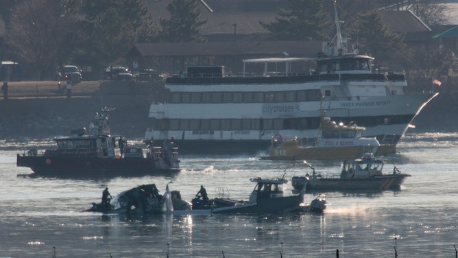 Emergency response units search the crash site of the American Airlines plane on the Potomac River after the plane crashed last night on approach to Reagan National Airport on January 30, 2025 in Arlington, Virginia.