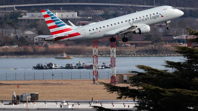 An American Eagle flight takes off from Reagan National Airport near where emergency crews work in the Potomac River on the crash site of an American Airlines plane on January 30, 2025 in Washington, DC.