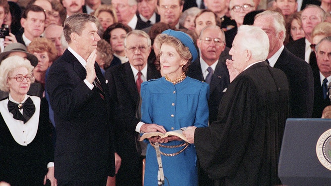 President Reagan is sworn in by Chief Justice Warren Burger in the Capitol Rotunda in a public inauguration ceremony.