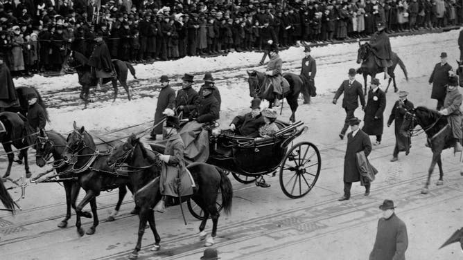 President Taft sits with his wife in a horse-drawn carriage during his Inaugural Parade.