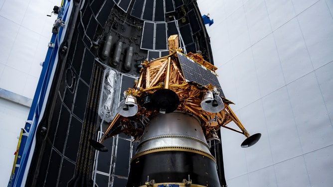 Firefly Aerospace's Blue Ghost lander encapsulated in SpaceX's rocket fairing ahead of launch at Kennedy Space Center in Florida.