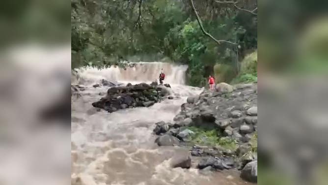 Girl is airlifted to safety from middle of rushing lao Stream on Maui Sunday.