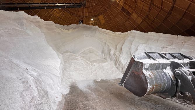 A truck scoops salt from a salt dome in Louisville, to get ready for treating roads.