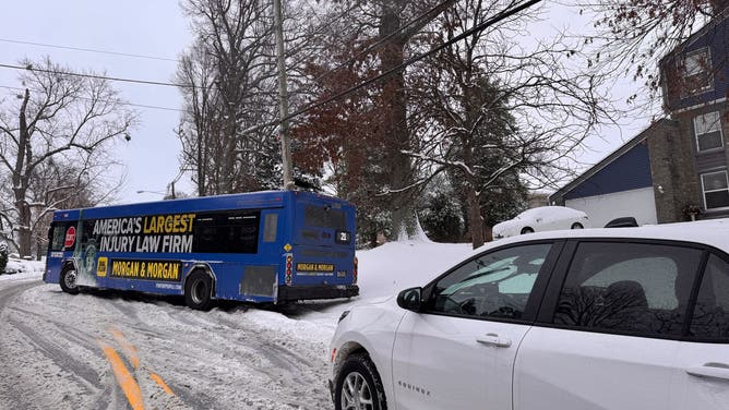 A city bus tries to navigate snow-covered streets in Louisville.