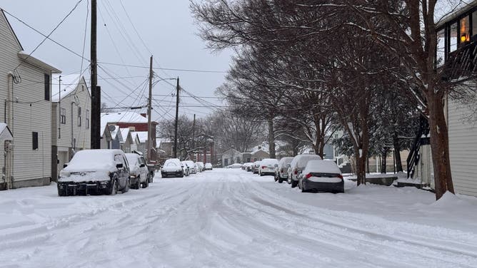 Snow-covered cars line a road in Louisville, Kentucky.